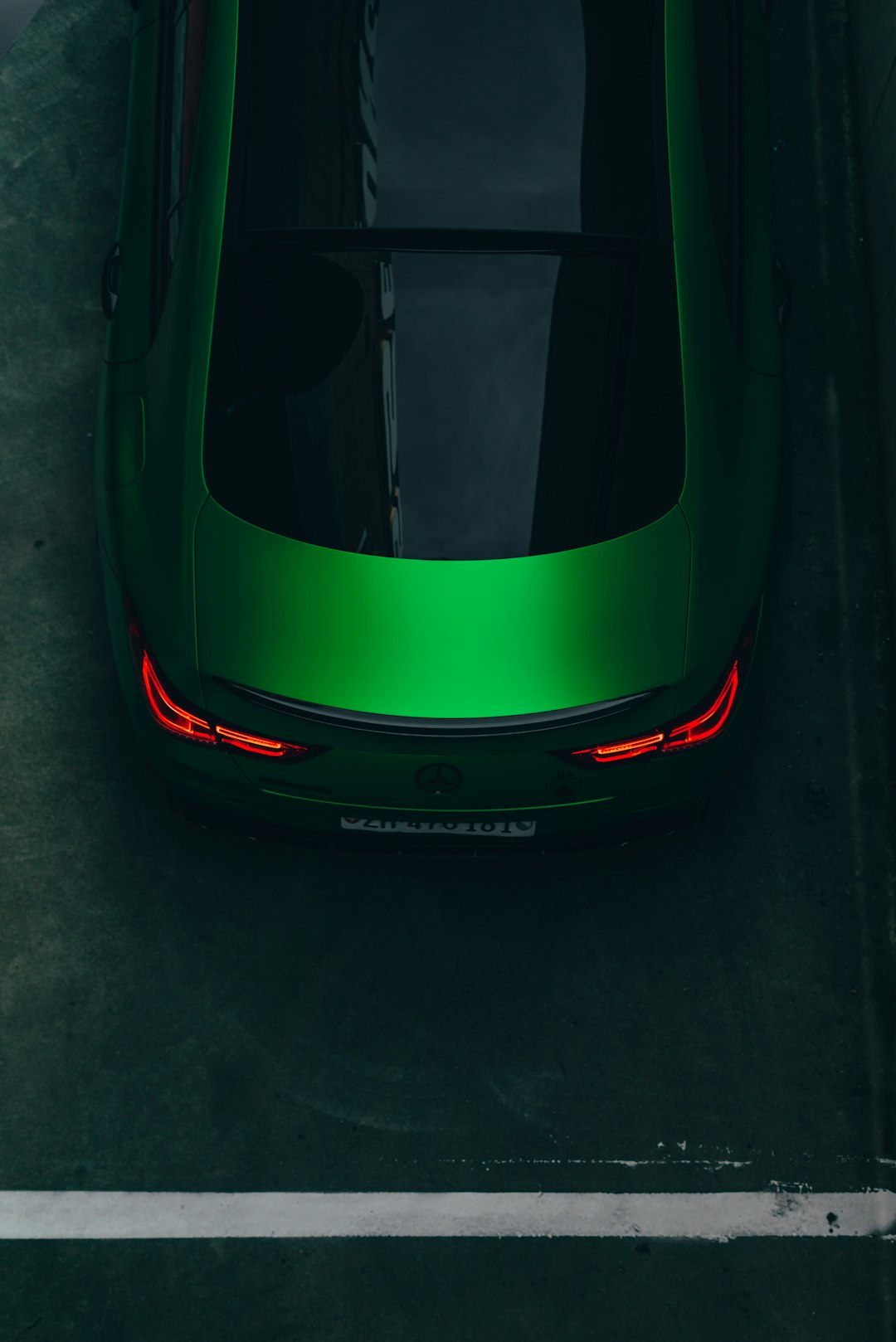 a-green-sports-car-parked-in-a-parking-lot-sdelnts79cq